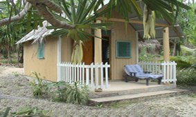 Nice one room bungallow on the beach, taken from the outside, from below a tree